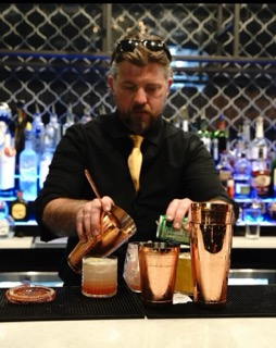 Bartender pouring handcrafted cocktails at Moustache Hookah Lounge in Sandy Springs