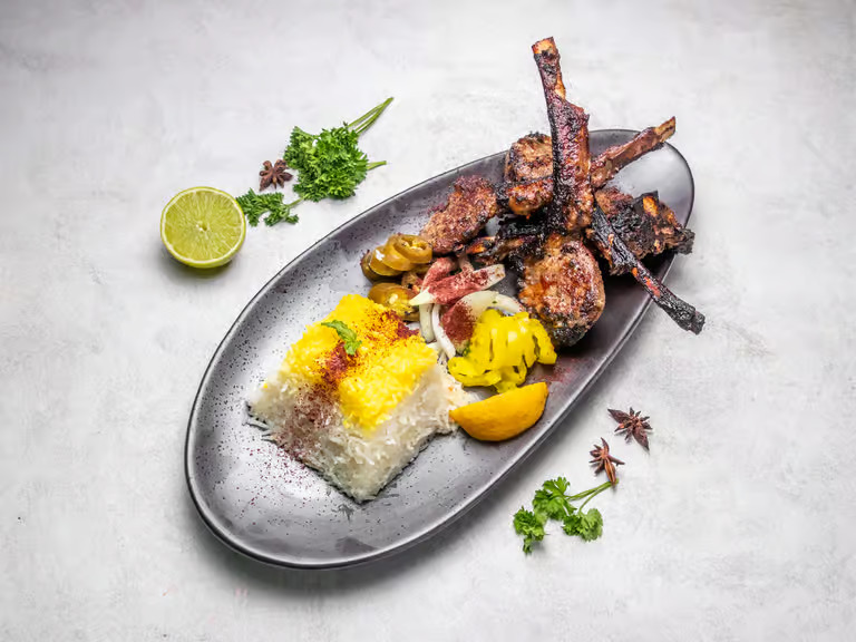 Grilled lamb chops and rice dish served at Moustache Lounge