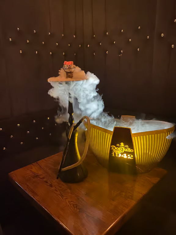 Romantic booth with hookah and candlelight at Moustache Lounge